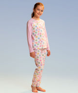 Young dancer wearing a pajama set with colorful candy hearts with dance sayings on a light blue background