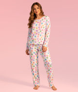 Dancer wearing a colorful pajama set with candy hearts that have dance sayings on a pink background