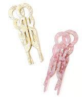 Four hair clips, two blonde beige and two pink, on a white background