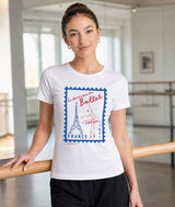 Ballerina in dance studio wearing white Covet Dance tee with France postage stamp ballet graphic