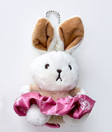 Plush toy rabbit ballerina keychain with brown ears and pink tutu skirt that is also a scrunchie on a white background