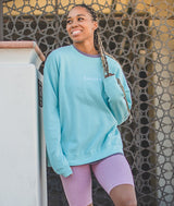 Dancer wearing Aqua Sweatshirt and pink bike shorts