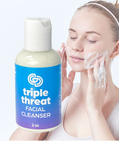 Girl washing face with Triple Threat Facial Cleanser
