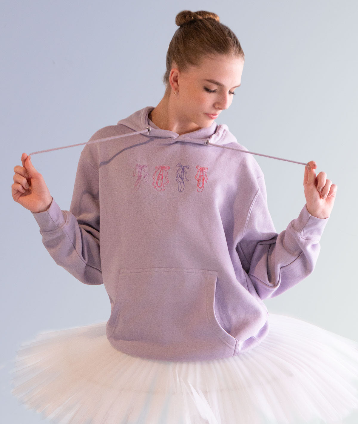 Four pointe shoe illustrations on a lilac hoodie for ballerinas