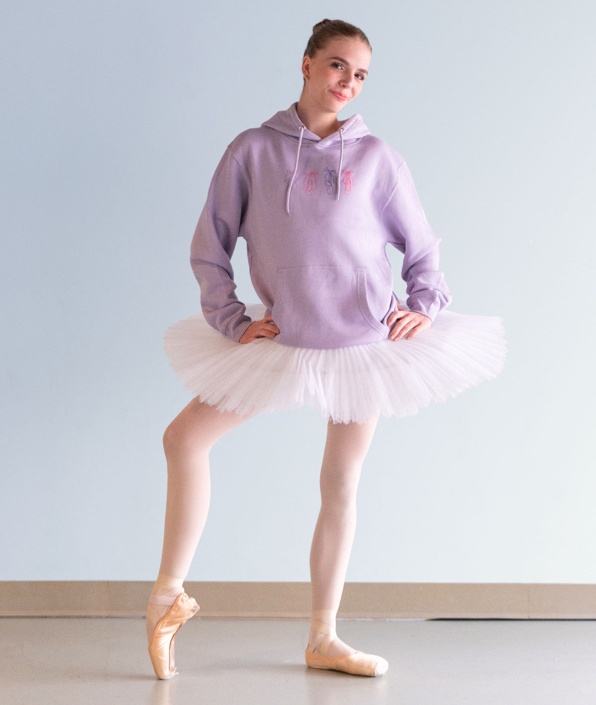 4 colorfully illustrated pointes shoes on a lilac hoodie for ballerinas