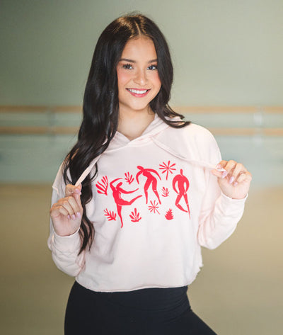 Matisse-inspired dancers on a pale pink cropped hooded sweatshirt