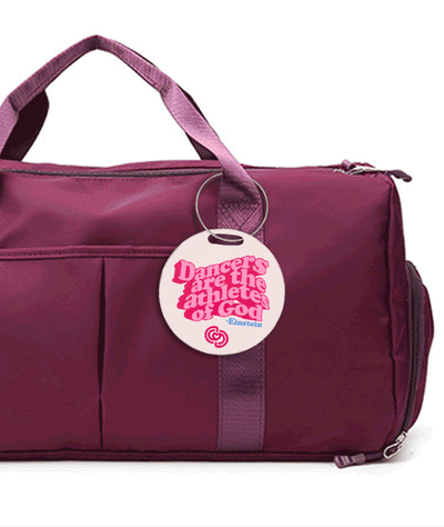 dance bag with metal luggage tag that has an inspirational dance quote