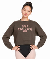 Dancer wearing a brown cropped sweatshirt with pink 'Dead Pointe Shoe Club' text on a white background