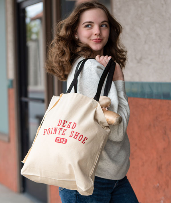 Ballerina on her way to class with the Covet Dance "Dead Pointe Shoe Tote Bag"