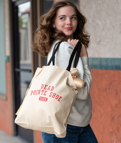 Ballerina on her way to class with the Covet Dance "Dead Pointe Shoe Tote Bag"