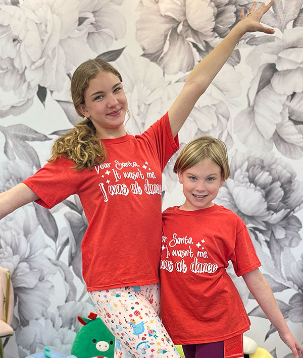 Dancing sisters wearing Covet Dance "Dear Santa" tees