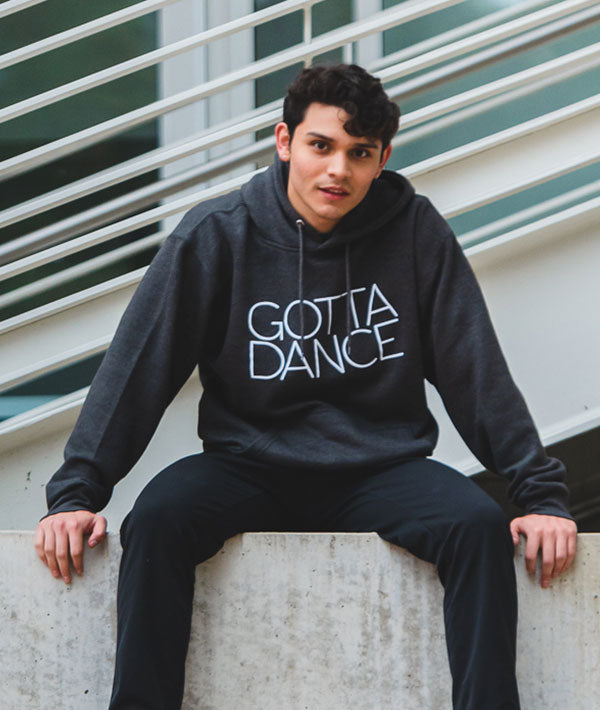 Male dancer wearing Gotta Dance hoodie in charcoal color