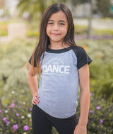 Young dancer posing in her Covet Dance raglan tee