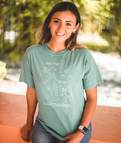 Dancer wearing the Covet Dance Not My First Nutcracker Tee sitting 