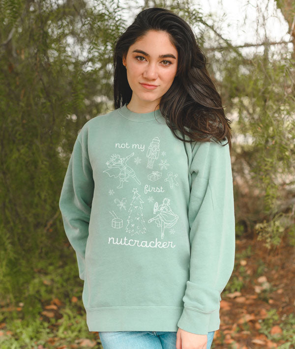 Dancer wearing Not My First Nutcracker crewneck outdoors after ballet rehearsal