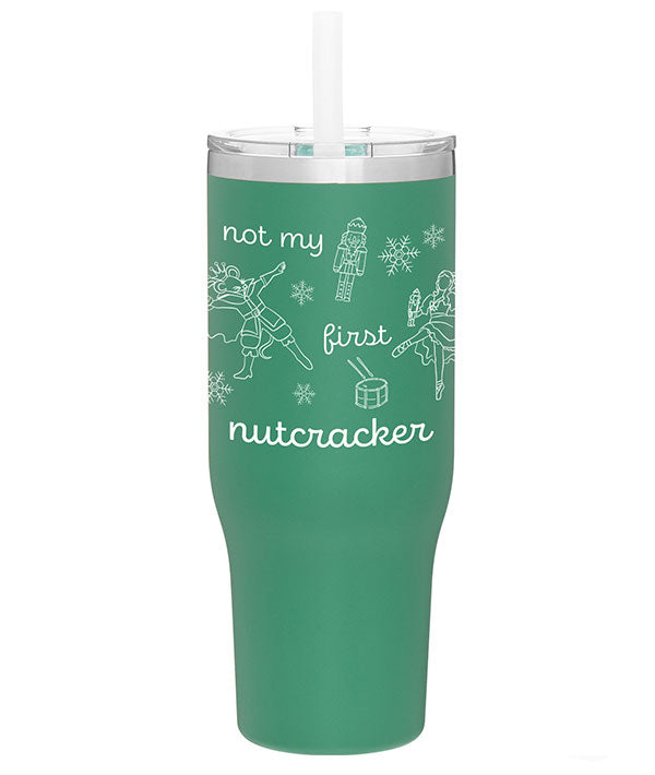 Green stainless steel tumbler with lid that says "Not my first nutcracker" in white print, with illustrations of the Nutcracker, Mouse King, Clara doing ballet in pointe shoes, and Christmas themed items: snowflakes and a drum.