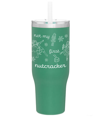 Green stainless steel tumbler with lid that says "Not my first nutcracker" in white print, with illustrations of the Nutcracker, Mouse King, Clara doing ballet in pointe shoes, and Christmas themed items: snowflakes and a drum.