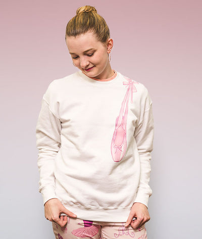 Ballerina sweatshirt with pointe shoe illustration hanging from shoulder