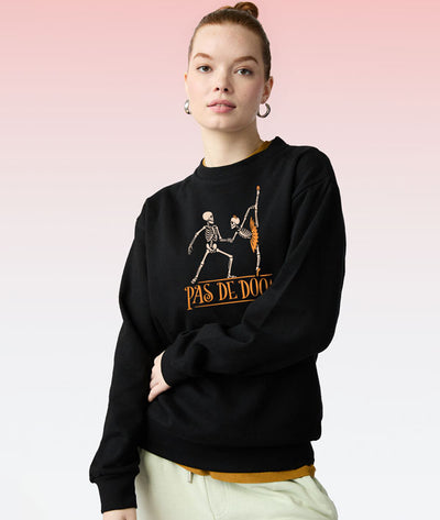 Dancer wearing a black Covet Dance sweatshirt with a ballet skeleton couple doing a Pas de Deux