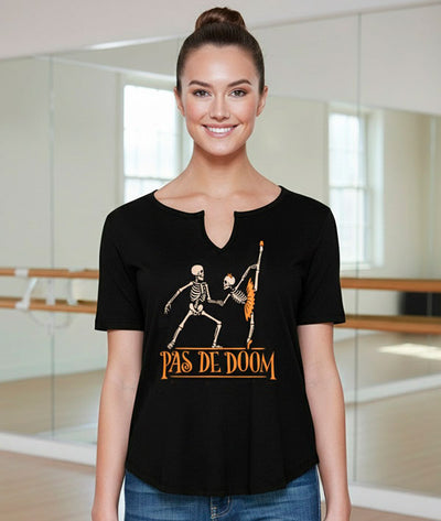 Dance teacher in a dance studio wearing a black slit v-neck t-shirt with two skeletons dancing a 'Pas de Deux' 