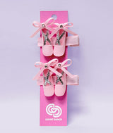 Pink ballet slipper shoes with decorative bows that are hair clips for little ballerinas sold as a set