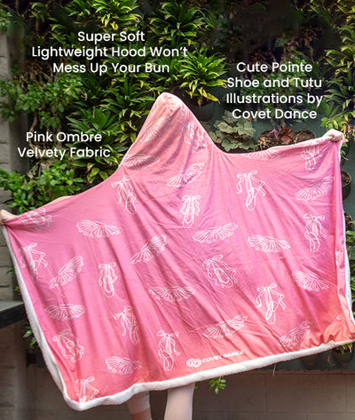 Pink ombre hooded blanket with ballet illustrations and text describing features, against a green leafy background.