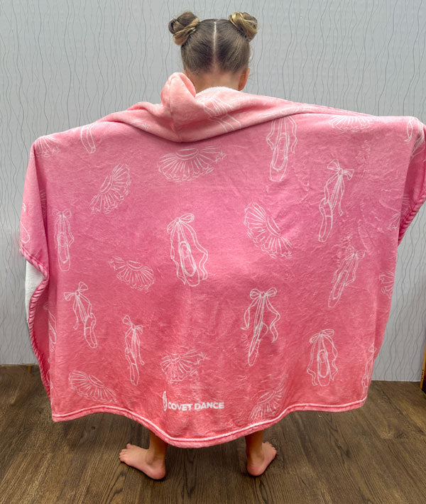 Young dancer wearing the Tutus and Pointe Shoes hooded blanket from Covet Dance