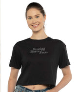 Dancer wearing a black crop t-shirt with 'Resting Barre Face' text on a white background