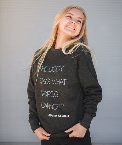 Contemporary dancer wearing "The body says what words cannot." Martha Graham quote sweatshirt