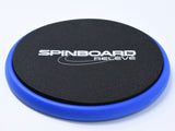 A round black foam SpinBoard Releve turning disc with a blue rim, placed on a white background.