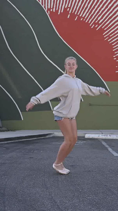 ballerina dancing and posing wearing trendy dance sweatshirt