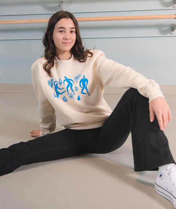 Young dancer wearing "Art of Dance" crewneck sweatshirt