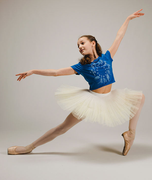Young Ballerina Wearing Crop Blue Tee with Zodiac Signs as Dancers