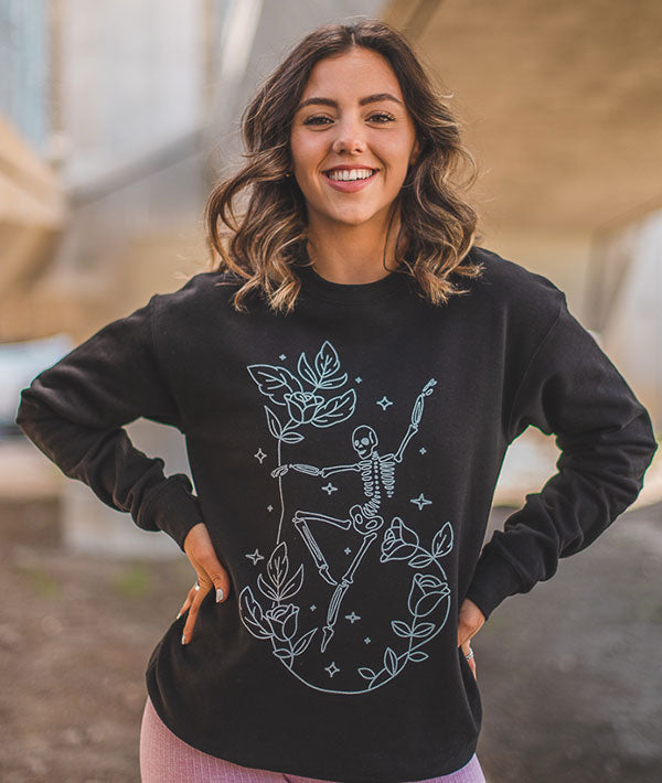 Dancing skeleton with roses and stars on a black sweatshirt