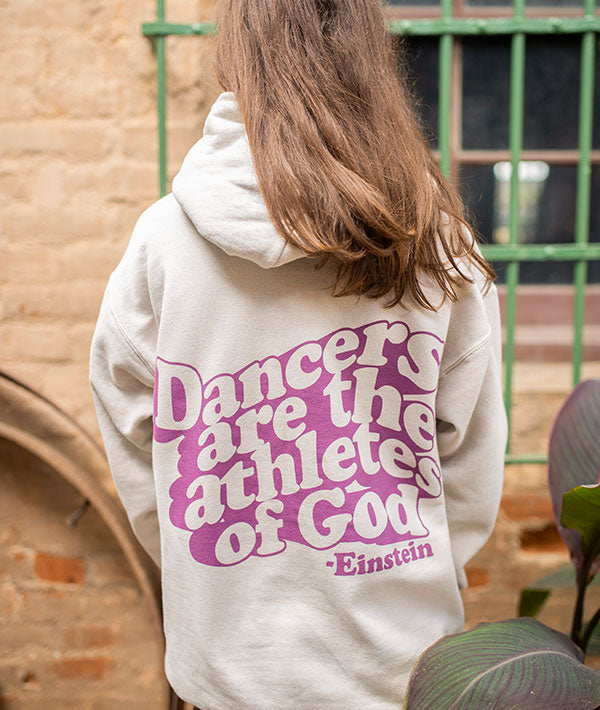 "Dancers are the athletes of God," quote on back of tan hoodie