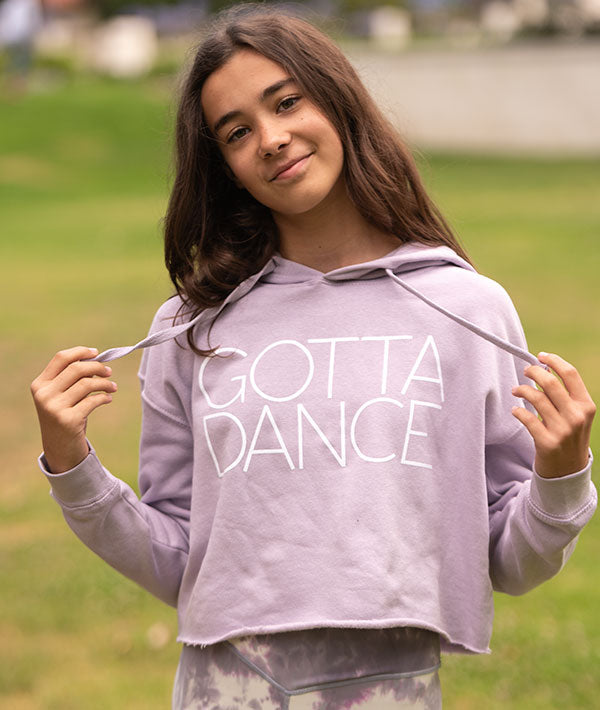 Young dancer wearing a cropped hoodie with GOTTA DANCE printed on it