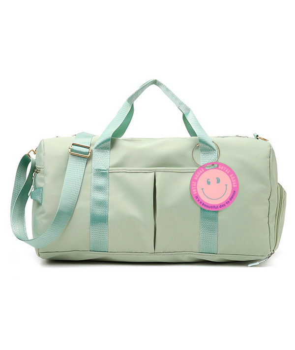 Mint-colored JOI Dance Duffel with "It's a Beautiful Day to Dance" aluminum luggage tag