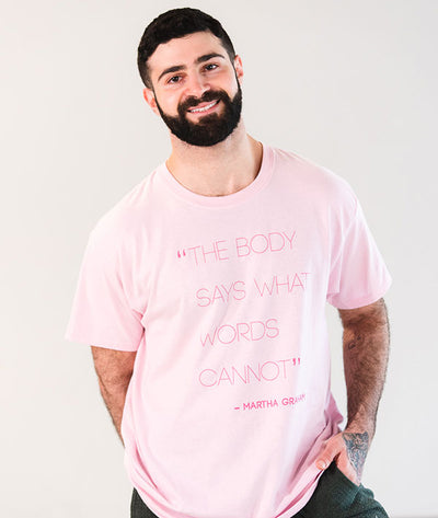 Male dancer wearing unisex pink tee with modern dance quote