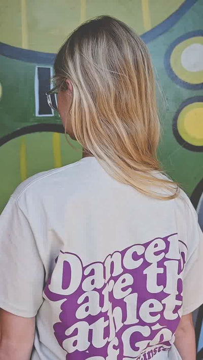 Ballerina wearing "Dancers are the athletes of God" quote on a t-shirt