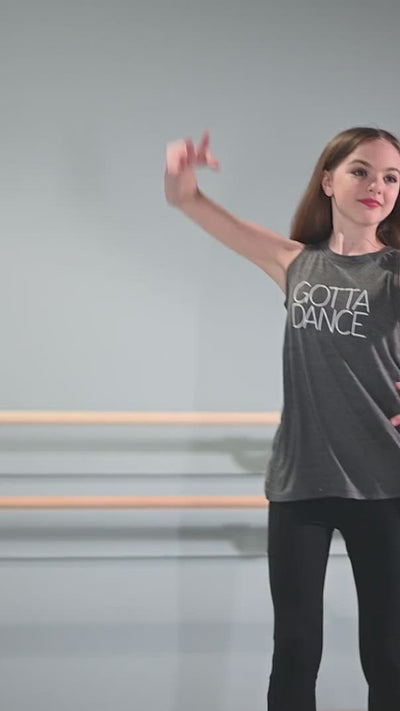 young ballerina in dance studio wearing dance apparel